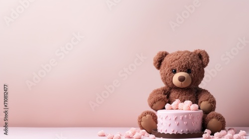  a teddy bear sitting on top of a cake with pink icing on the bottom of it and a pink wall in the background.