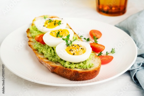 Avocado toast with toasted bread soft-boiled eggs with tomatoes