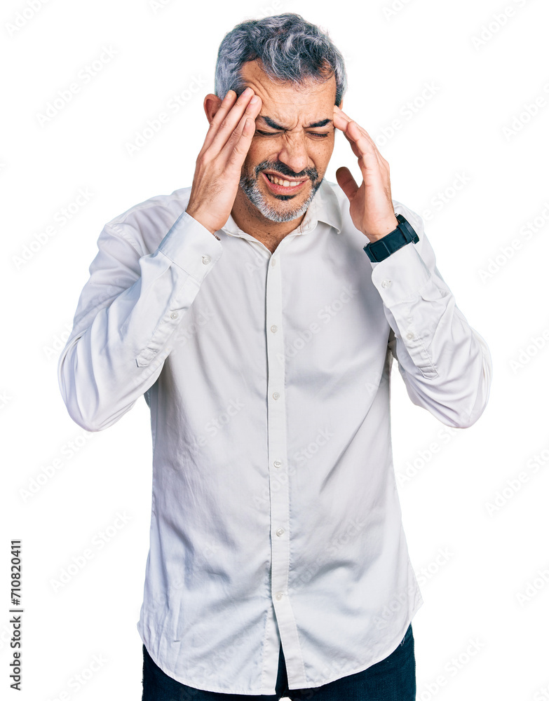 Middle age hispanic with grey hair wearing casual white shirt with hand on head, headache because stress. suffering migraine. Middle age hispanic with grey hair wearing casual white shirt with hand on head, headache because stress. suffering migraine.