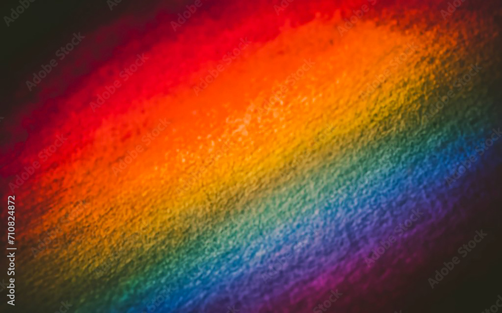 A softly focused picture capturing a textured gradient backdrop with a colorful array reminiscent of a rainbow
