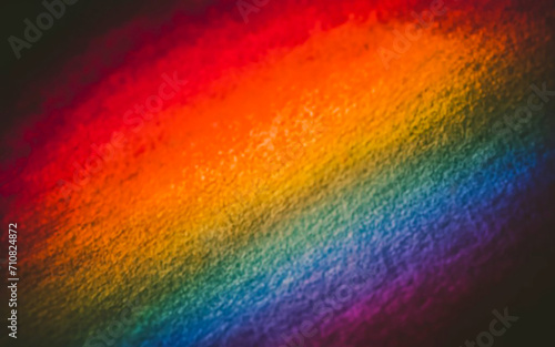 A softly focused picture capturing a textured gradient backdrop with a colorful array reminiscent of a rainbow