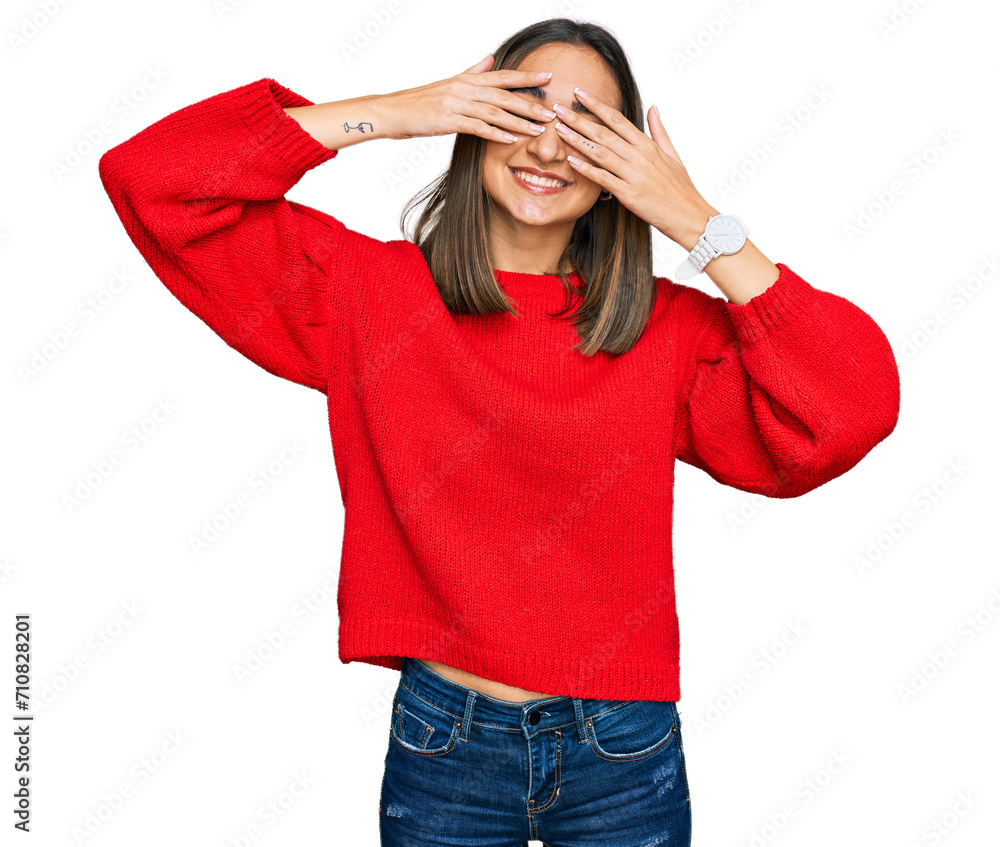 Beautiful brunette woman wearing casual winter sweater covering eyes with hands smiling cheerful and funny. blind concept. Beautiful brunette woman wearing casual winter sweater covering eyes with hands smiling cheerful and funny. blind concept.