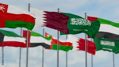 Gulf Cooperation Council or GCC flags waving together on cloudy sky, endless seamless loop photo