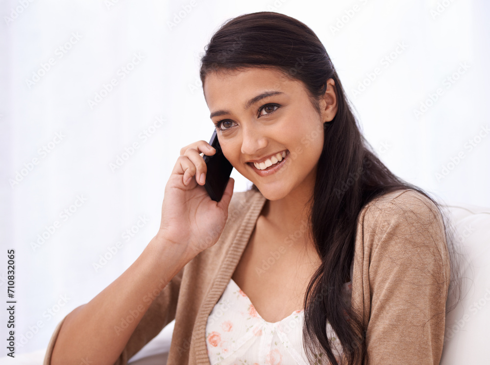 Happy woman on couch with phone call, relax and conversation with mobile connection in apartment. Indian girl sitting on sofa with smile, talking on cellphone and communication for networking in home Happy woman on couch with phone call, relax and conversation with mobile connection in apartment. Indian girl sitting on sofa with smile, talking on cellphone and communication for networking in home