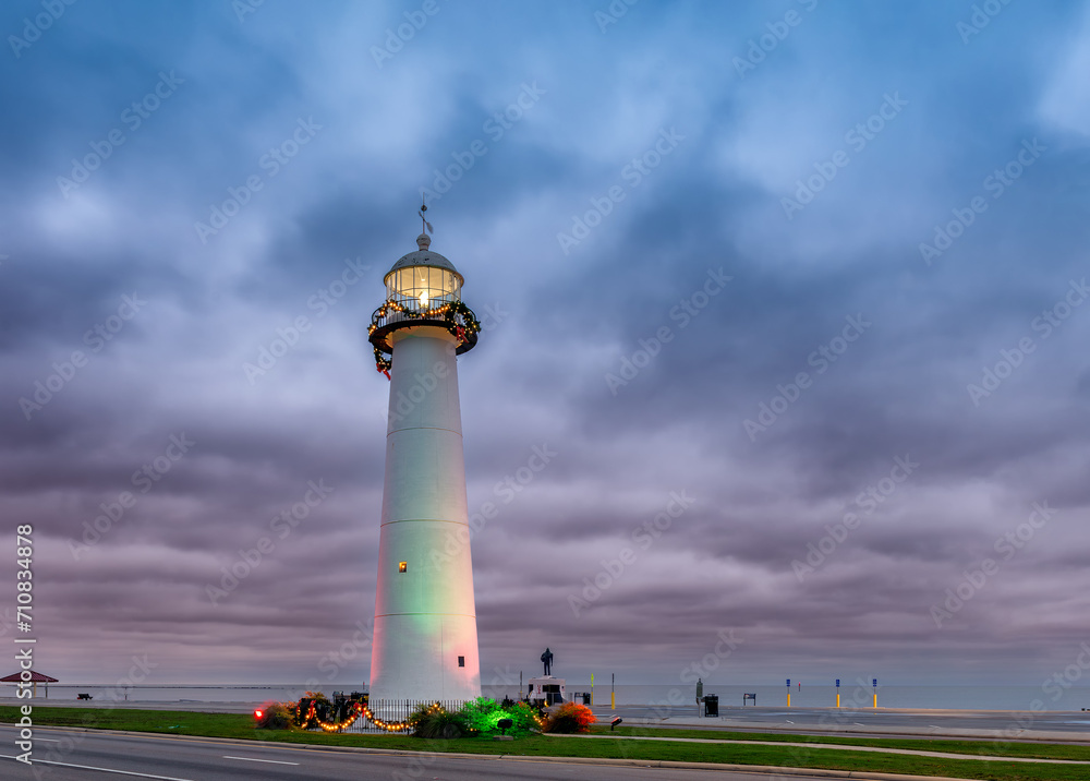 Biloxi Lighthouse at sunrise with dramatic stormy sky in Biloxi, Mississippi, USA.