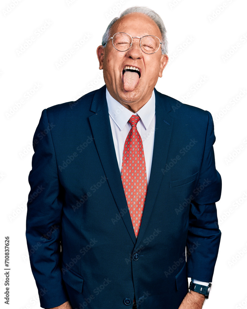 Senior man with grey hair wearing business suit and glasses sticking tongue out happy with funny expression. emotion concept. Senior man with grey hair wearing business suit and glasses sticking tongue out happy with funny expression. emotion concept.
