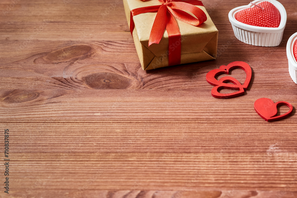 Valentines day frame with gift box and red heart, candles on a wooden background. Valentines day banner with copy space Valentines day frame with gift box and red heart, candles on a wooden background. Valentines day banner with copy space
