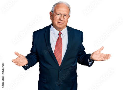 фотографія Senior man with grey hair wearing business suit and glasses clueless and confused with open arms, no idea concept