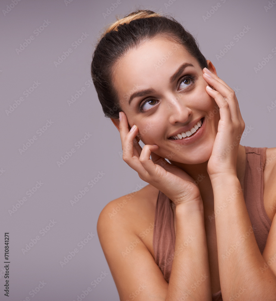 Woman, face and beauty, cosmetics and skincare with dermatology for healthy glow on purple background. Hands on skin, happy with smile and wellness, self care and grooming for hygiene in studio Woman, face and beauty, cosmetics and skincare with dermatology for healthy glow on purple background. Hands on skin, happy with smile and wellness, self care and grooming for hygiene in studio
