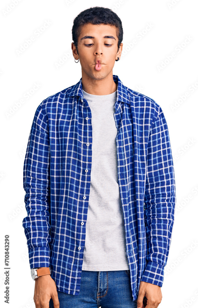 Young african amercian man wearing casual clothes making fish face with lips, crazy and comical gesture. funny expression. Young african amercian man wearing casual clothes making fish face with lips, crazy and comical gesture. funny expression.