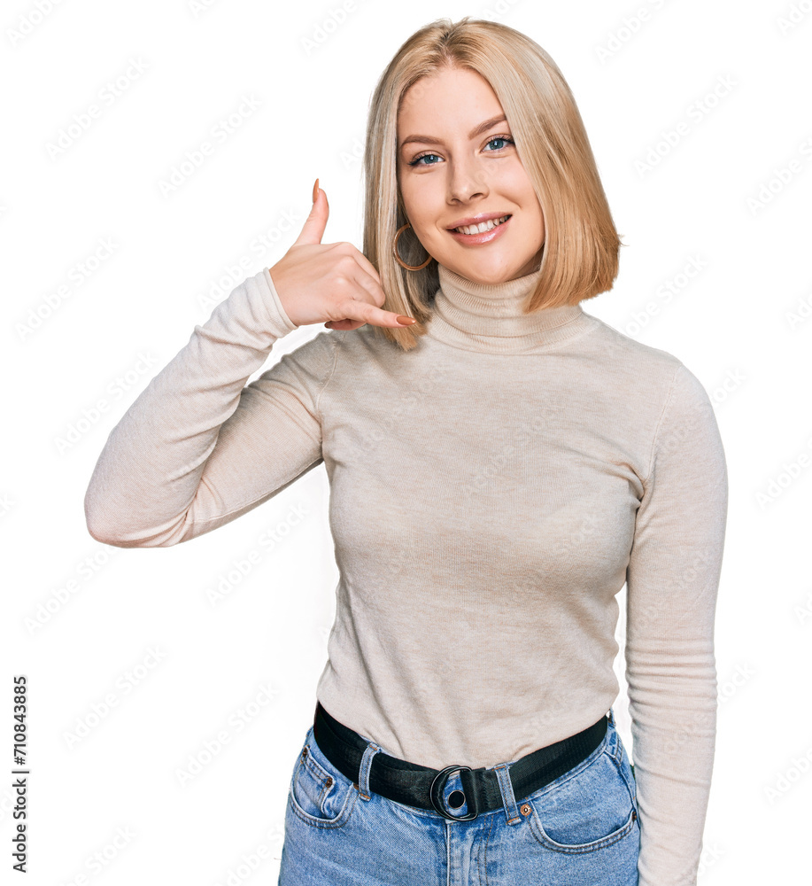Young blonde woman wearing casual clothes smiling doing phone gesture with hand and fingers like talking on the telephone. communicating concepts. Young blonde woman wearing casual clothes smiling doing phone gesture with hand and fingers like talking on the telephone. communicating concepts.