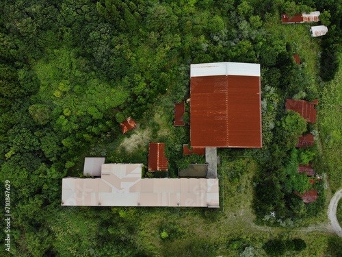 aerial view of abandoned old school reclaimed by nature © Benedikt