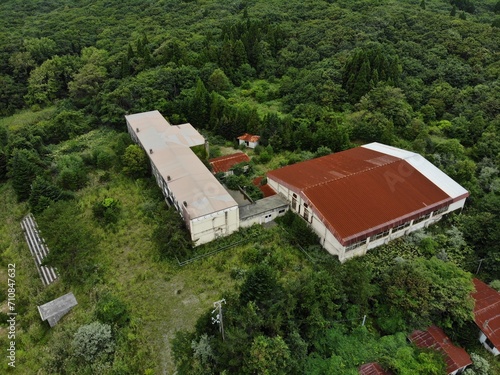 aerial view of abandoned old school reclaimed by nature