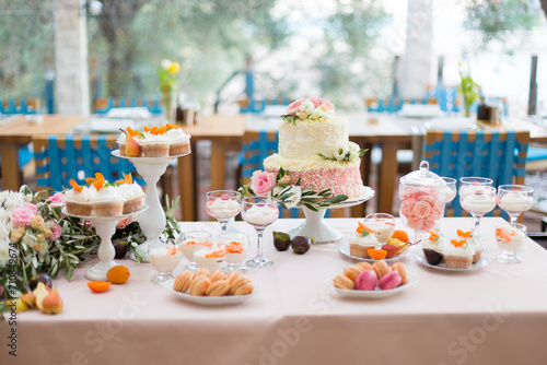 Dessert table for a party. Cake, cupcakes, sweetness and flowers
