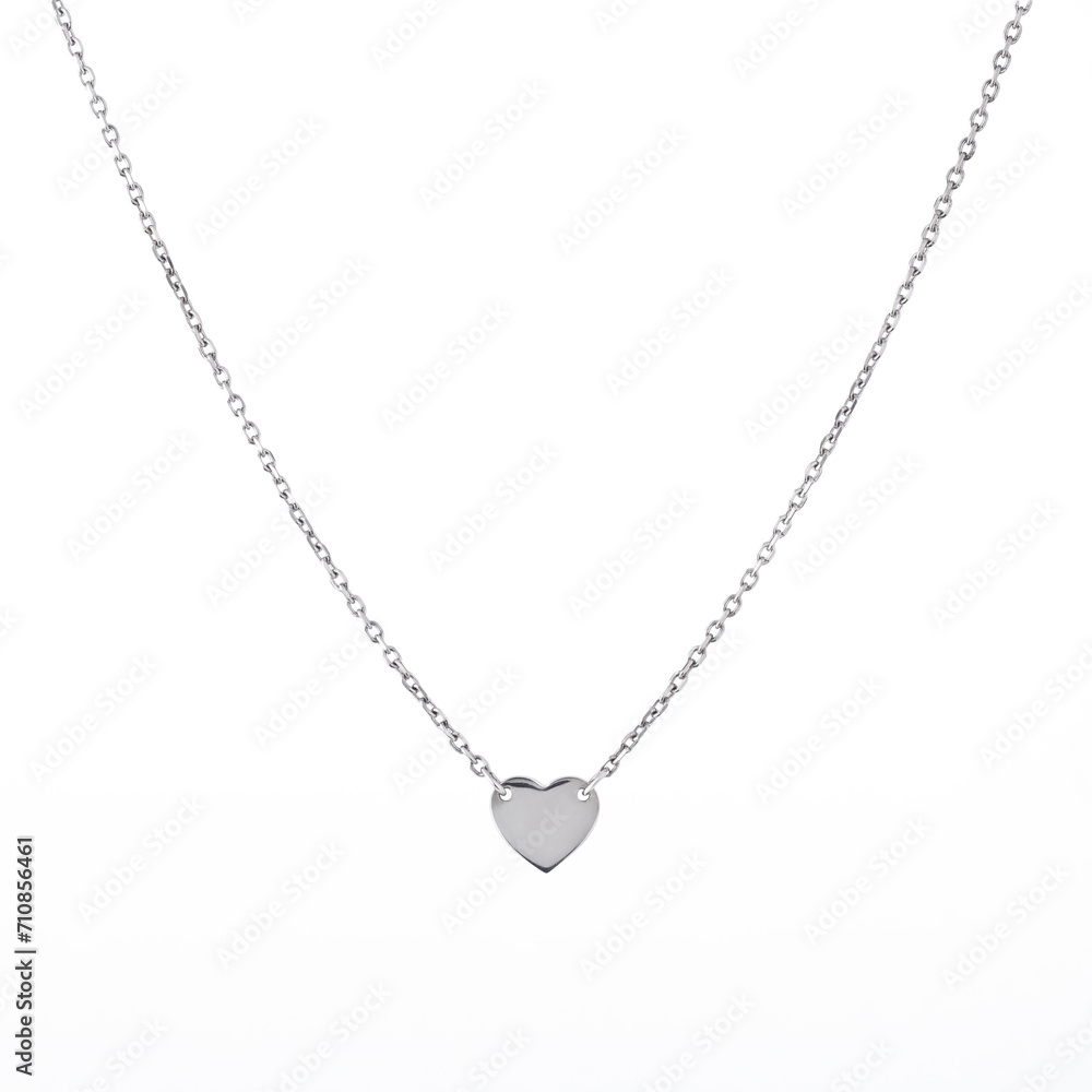 Female heart shaped pendant with silver chain necklace isolated on white background Female heart shaped pendant with silver chain necklace isolated on white background