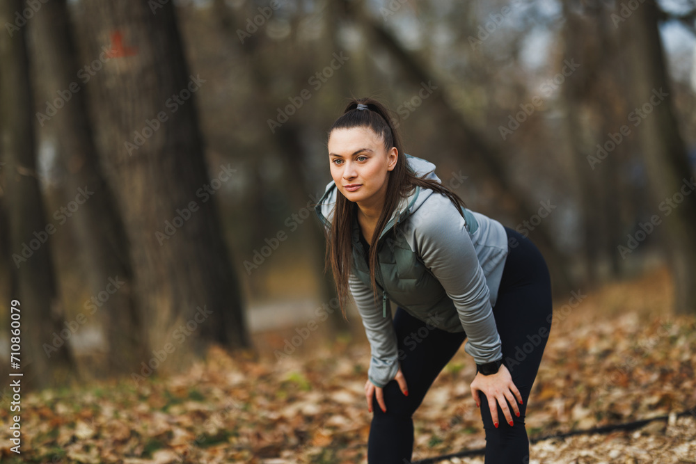 Woman Taking a Break After Running in a Park During Autumn Woman Taking a Break After Running in a Park During Autumn