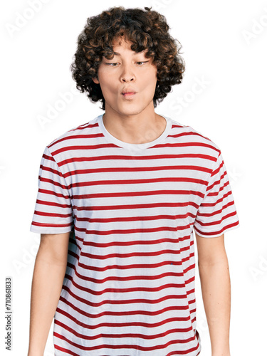 Caucasian teenager wearing casual clothes making fish face with lips, crazy and comical gesture. funny expression.