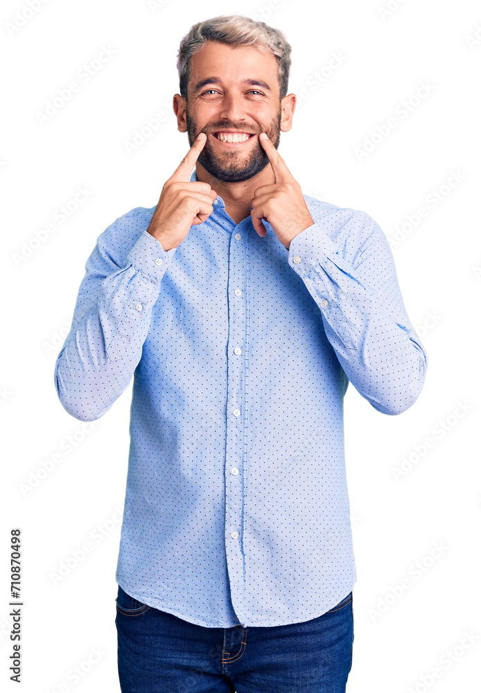 Young handsome blond man wearing elegant shirt smiling with open mouth, fingers pointing and forcing cheerful smile Young handsome blond man wearing elegant shirt smiling with open mouth, fingers pointing and forcing cheerful smile