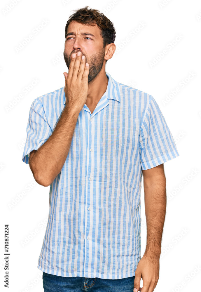 Handsome young man with beard wearing casual fresh shirt bored yawning tired covering mouth with hand. restless and sleepiness. Handsome young man with beard wearing casual fresh shirt bored yawning tired covering mouth with hand. restless and sleepiness.