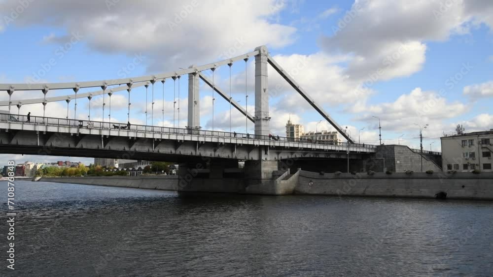 City view from tour boat sailing next to bridge on Moskva river in a sunny autumn day in Moscow, Russia. Soft focus. Real time handheld video. Water travel theme. City view from tour boat sailing next to bridge on Moskva river in a sunny autumn day in Moscow, Russia. Soft focus. Real time handheld video. Water travel theme.