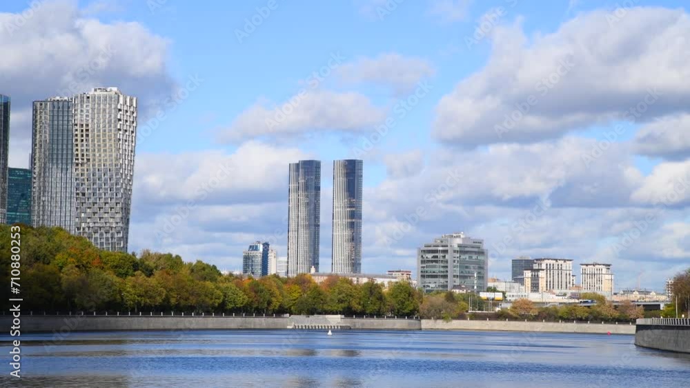 City view from sailing tour boat in a sunny autumn day in Moscow, Russia. Group of modern office and apartment buildings in the background. Soft focus. Real time handheld video. City life theme. City view from sailing tour boat in a sunny autumn day in Moscow, Russia. Group of modern office and apartment buildings in the background. Soft focus. Real time handheld video. City life theme.