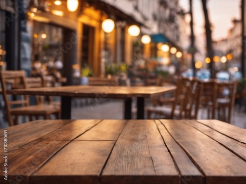 Empty wooden table with a blurred cafe terrace in the background, inviting and ideal for product display.