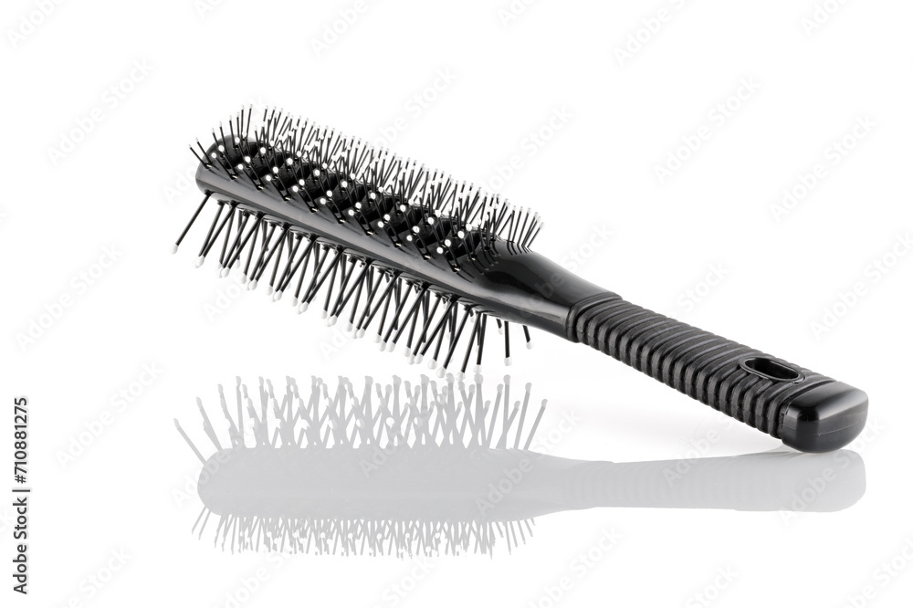 Black double sided hair brush with handle isolated on white background. Combing and hair care, hairdressing tools, haberdashery. Close-up. Black double sided hair brush with handle isolated on white background. Combing and hair care, hairdressing tools, haberdashery. Close-up.