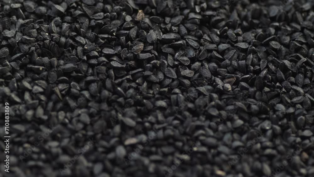 close-up black cumin seeds heap rotation. slow motion. macro heap black cumin seeds close-up black cumin seeds heap rotation. slow motion. macro heap black cumin seeds