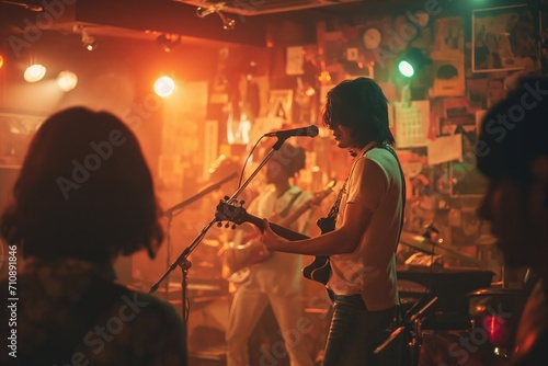 A rock band plays a live performance in a small club in Tokyo, Japan. 