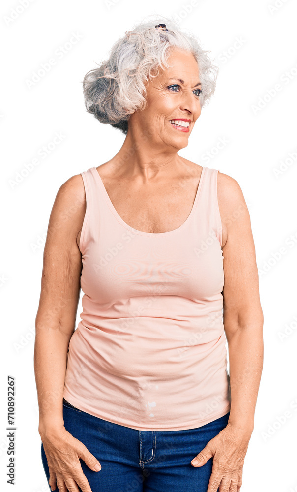 Senior grey-haired woman wearing casual clothes looking away to side with smile on face, natural expression. laughing confident. Senior grey-haired woman wearing casual clothes looking away to side with smile on face, natural expression. laughing confident.