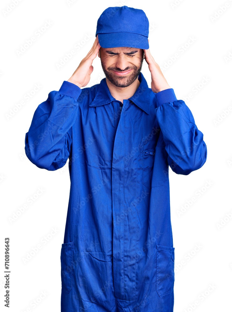 Young hispanic man wearing painter uniform suffering from headache desperate and stressed because pain and migraine. hands on head. Young hispanic man wearing painter uniform suffering from headache desperate and stressed because pain and migraine. hands on head.