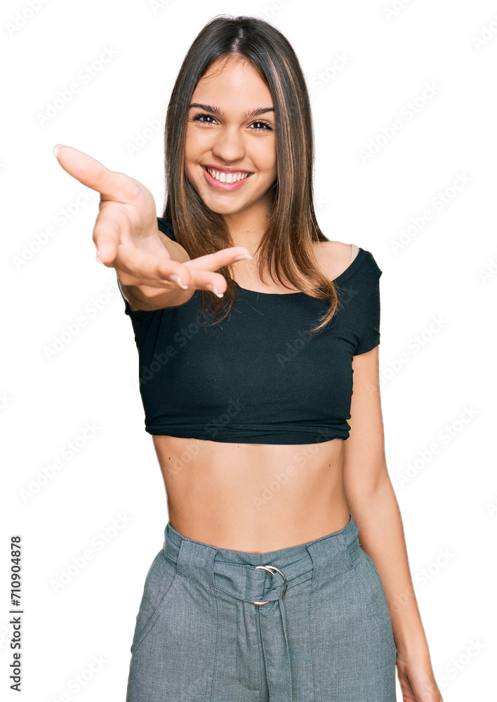 Young brunette woman wearing casual clothes smiling friendly offering handshake as greeting and welcoming. successful business. Young brunette woman wearing casual clothes smiling friendly offering handshake as greeting and welcoming. successful business.