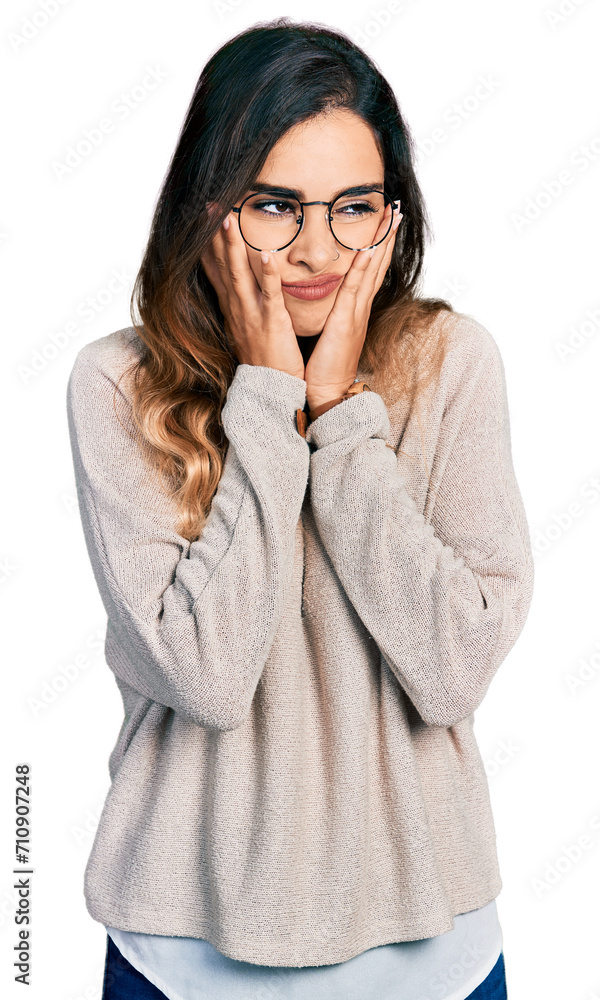 Beautiful hispanic woman wearing casual sweater and glasses tired hands covering face, depression and sadness, upset and irritated for problem Beautiful hispanic woman wearing casual sweater and glasses tired hands covering face, depression and sadness, upset and irritated for problem