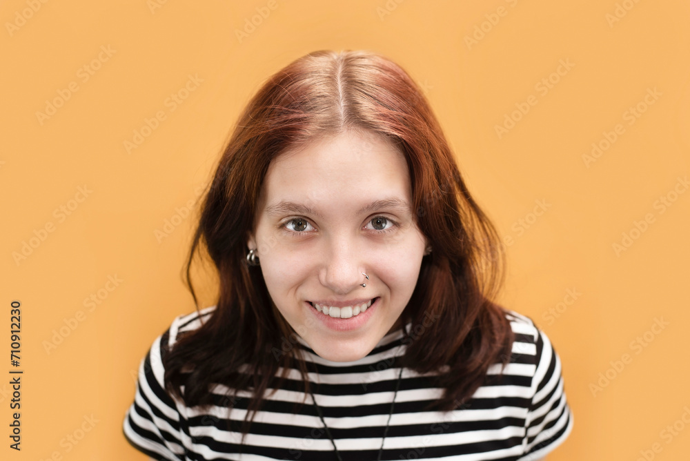 Portrait of a happy teenage girl with big beautiful eyes, her hair is growing, it's time to go to the hairdresser again to paint her hair. Happy healthy teenage girl Portrait of a happy teenage girl with big beautiful eyes, her hair is growing, it's time to go to the hairdresser again to paint her hair. Happy healthy teenage girl