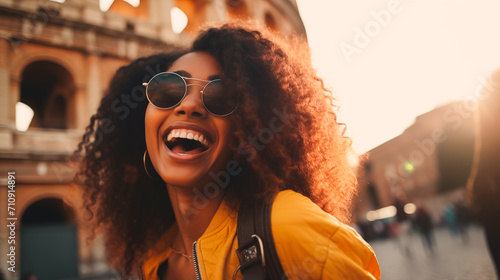 Fototapeta Young black woman in sunglasses taking selfie portrait on city street. Female having fun on vacation outdoor in front of the colosseum, Rome, Italy. Generative AI
