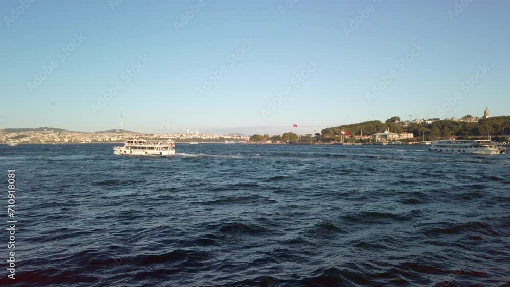 Evening, cinematic slow-mo, breathtaking view of Sarayburnu from ferry on Golden Horn in Istanbul. The shot showcases Hagia Sophia, the cityscape, the Bosphorus, Camlica Tower, and moving ferries. Evening, cinematic slow-mo, breathtaking view of Sarayburnu from ferry on Golden Horn in Istanbul. The shot showcases Hagia Sophia, the cityscape, the Bosphorus, Camlica Tower, and moving ferries.