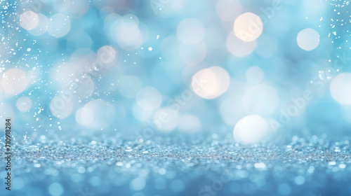 Light blue background with bokeh and defocused sparkles falling down. Festive abstract banner with smokey blue backdrop and illuminated bokeh particles. © Marina_Nov