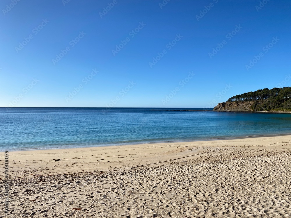 Island beach. View of bay, sand, waves and coastline. Landscape near the ocean.