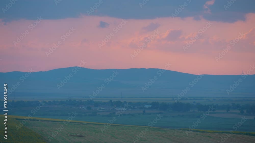 Pan left view of a summer sunset with wind turbines at horizone Pan left view of a summer sunset with wind turbines at horizone