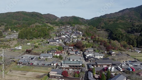 Aerial jib shot of Magome, aka Magome-juku, during autumn season in Japan. Magome is a former post town on the Nakasendo trail, a major route that connected Tokyo with Kyoto in the feudal ages. photo