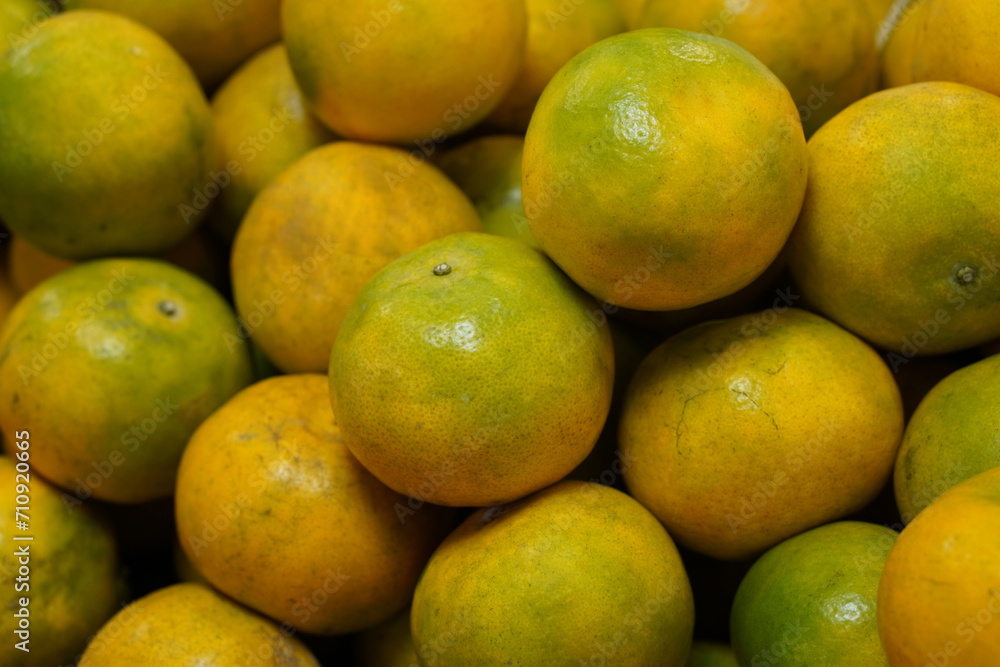 yellow and green oranges stacked on nature background, fruit, food, delicious, copy space yellow and green oranges stacked on nature background, fruit, food, delicious, copy space