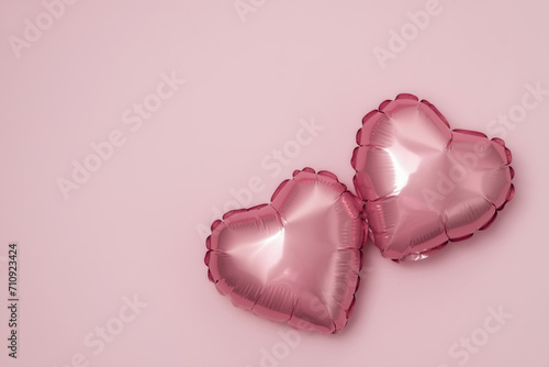 Pink background with red hearts balloons