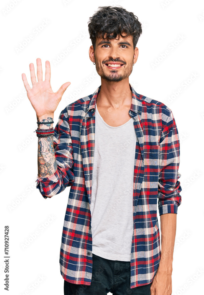 Young hispanic man wearing casual clothes showing and pointing up with fingers number five while smiling confident and happy. Young hispanic man wearing casual clothes showing and pointing up with fingers number five while smiling confident and happy.