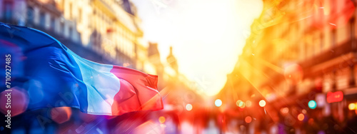 flag of France fluttering in the breeze, set against a blurred cityscape bathed in the golden light of sunset, evoking a sense of national pride and dynamic movement