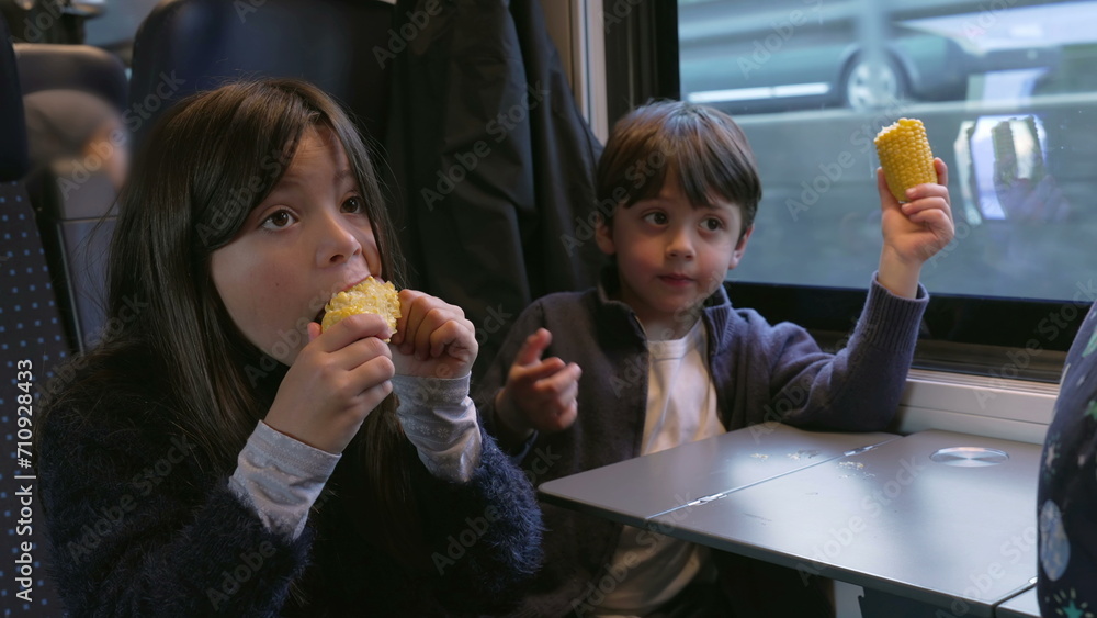 Siblings Snacking Corn in Moving Train - Brother and Sister Enjoying Healthy Food Siblings Snacking Corn in Moving Train - Brother and Sister Enjoying Healthy Food