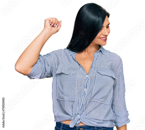 Obraz na plátně Young caucasian woman wearing casual clothes dancing happy and cheerful, smiling