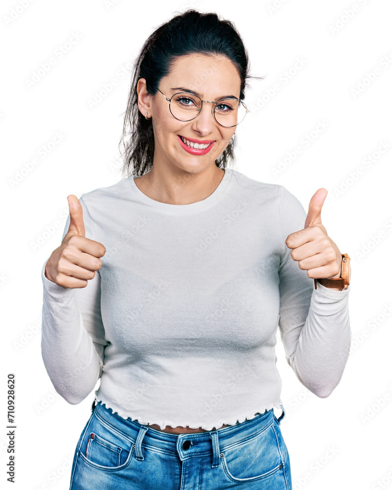 Young hispanic woman wearing casual clothes success sign doing positive gesture with hand, thumbs up smiling and happy. cheerful expression and winner gesture. Young hispanic woman wearing casual clothes success sign doing positive gesture with hand, thumbs up smiling and happy. cheerful expression and winner gesture.