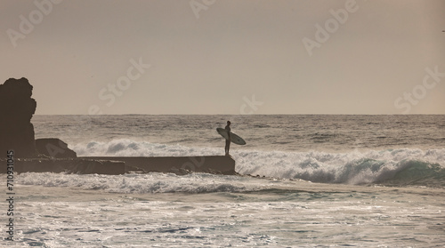 Surfero observando el mar antes de entrar a surfear olas en un mar furioso © Zek Jim