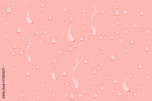 Liquid pink wet drops of gel or collagen.Spilled puddles of cosmetic serum or water. Round clean swatch of essence lotion or jelly for skin care.Beauty background with oil drops.