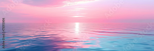Morning sunrise, blue sea, pink sky, yellow sun glow, golden reflection on water.
